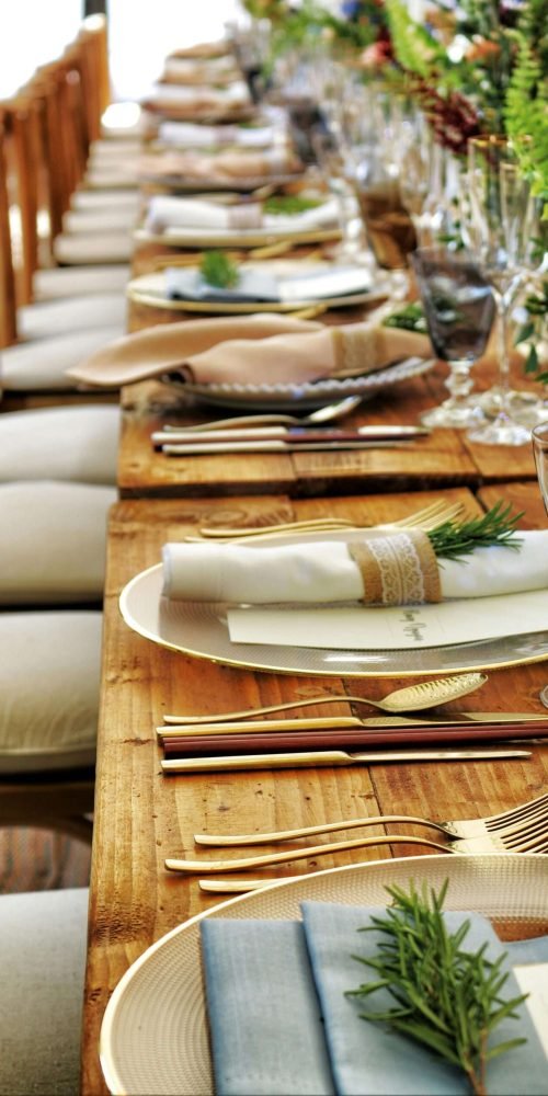 Close-up of a beautifully arranged table setting with flowers and cutlery, perfect for weddings or fine dining.
