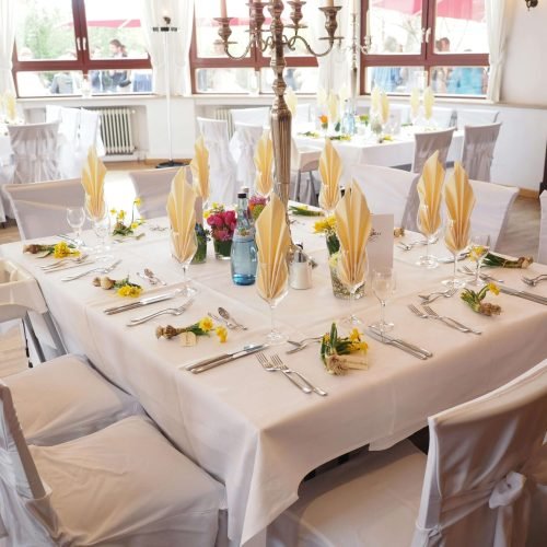 A beautifully decorated dining room table set for an elegant celebration indoors.
